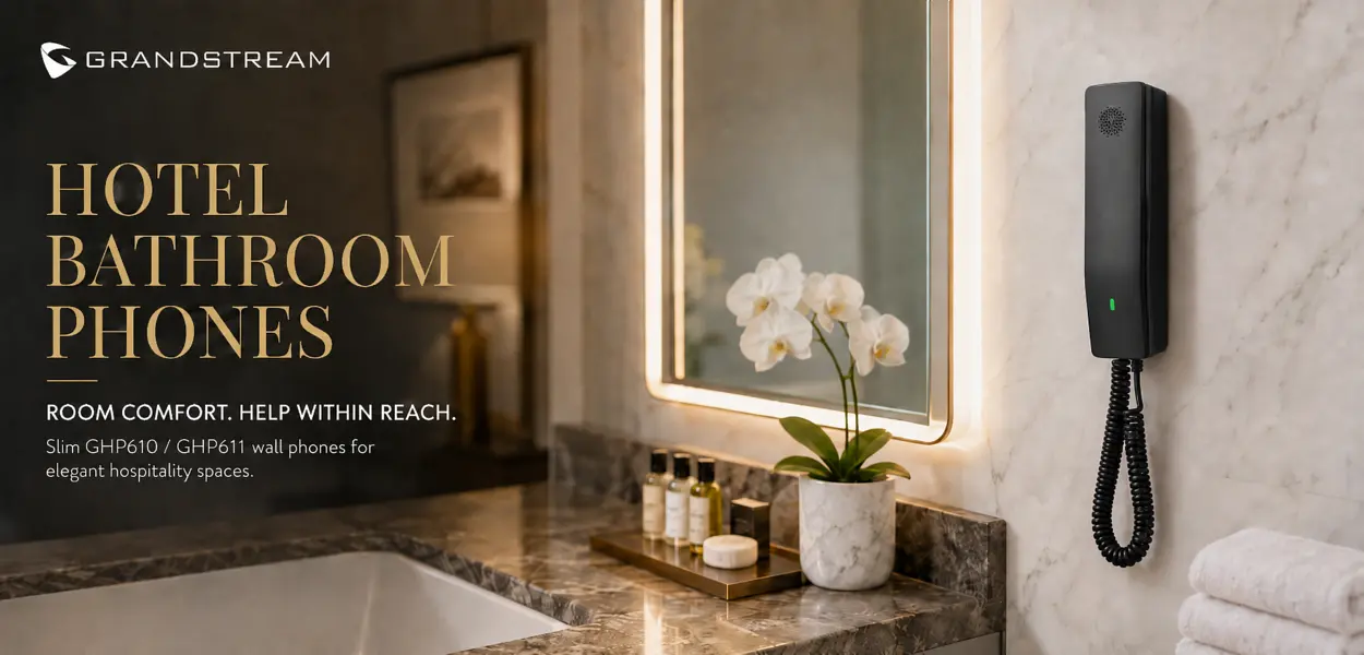 Grandstream GHP611 slimline hotel bathroom phone wall-mounted beside a vanity mirror
